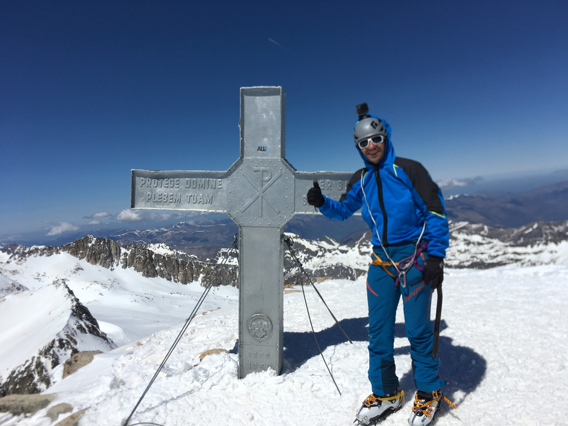 Standing beside the summit cross on Aneto