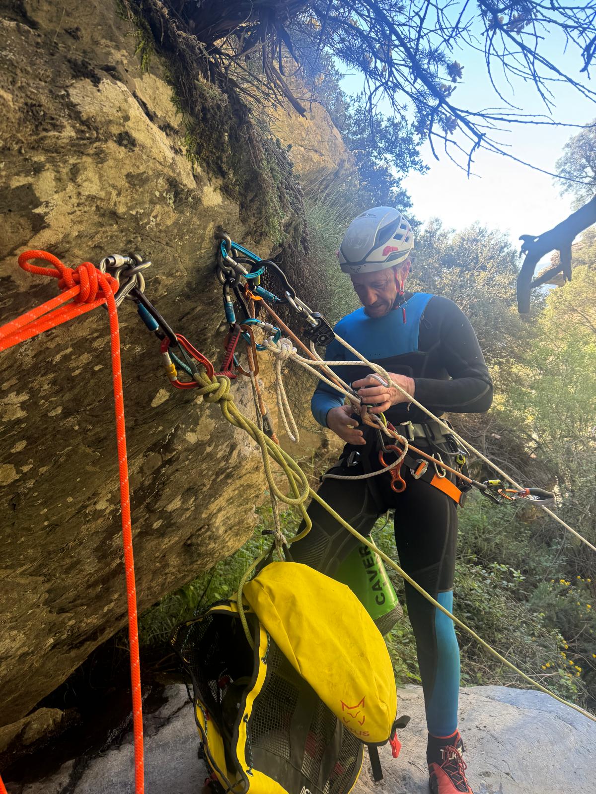 Instructor setting up anchors and ropes on the rock