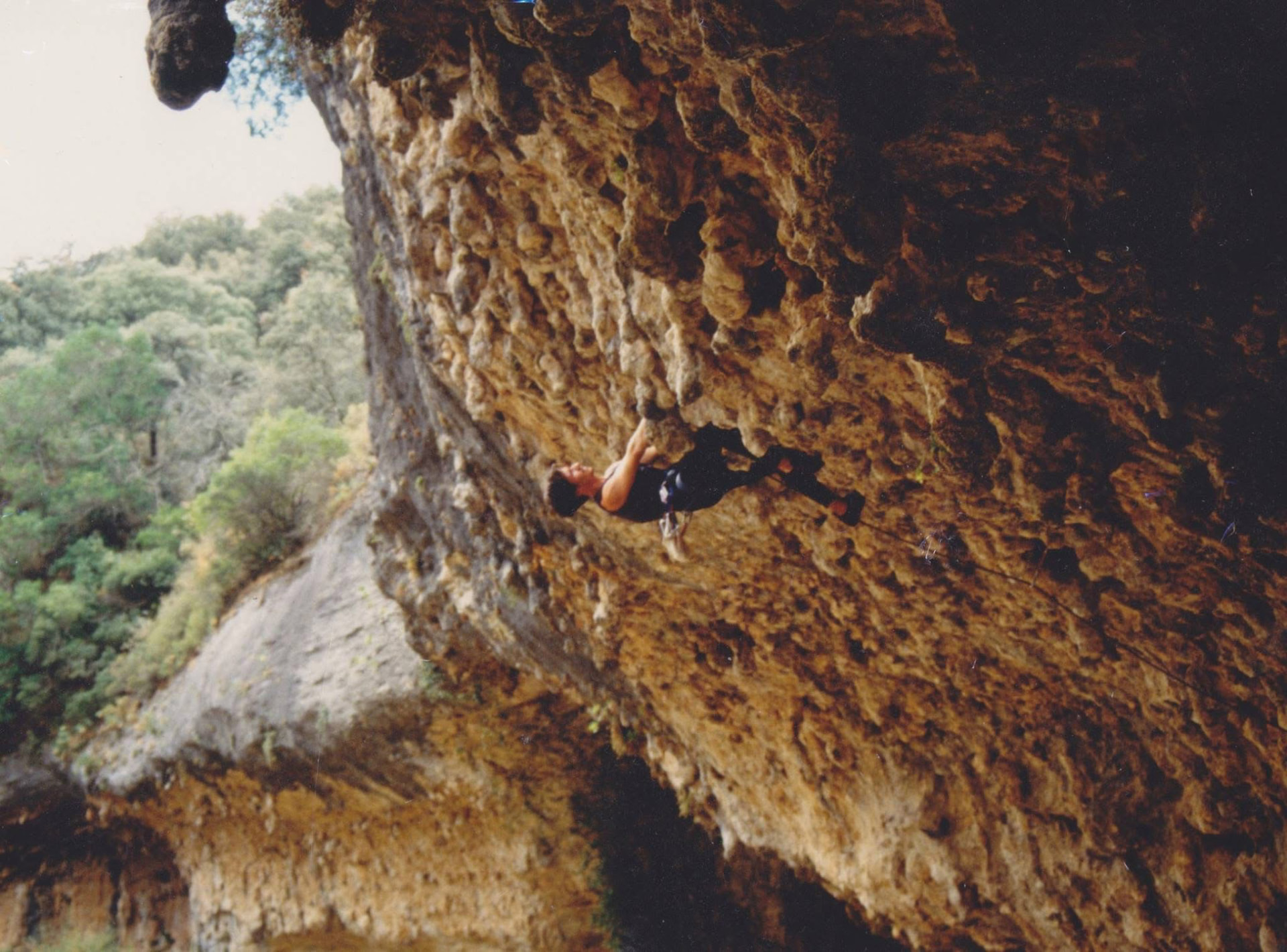 Climbing across a steep rock overhang